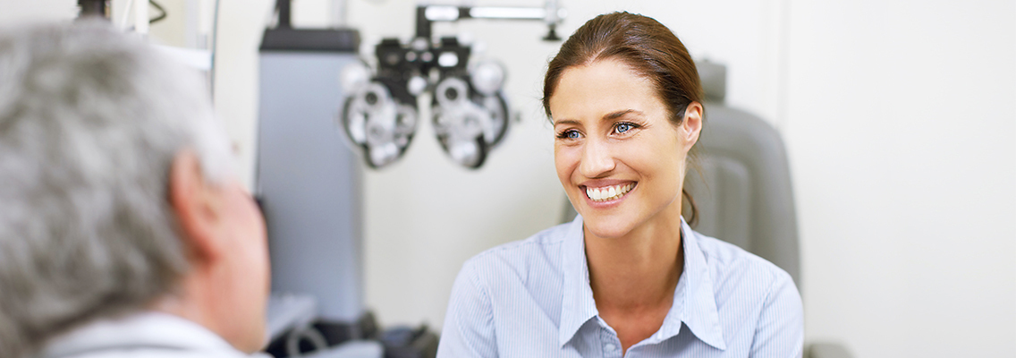 woman smiling with an eye care practitioner