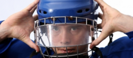 young boy wearing a football helmet