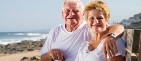 mature couple smiling at the beach