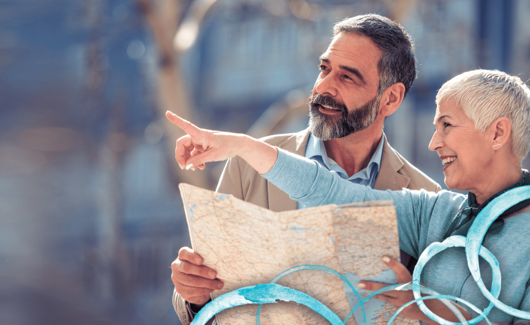 mature man and woman smiling and looking at a map