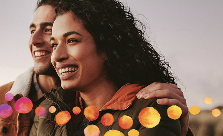man and woman smiling outdoors