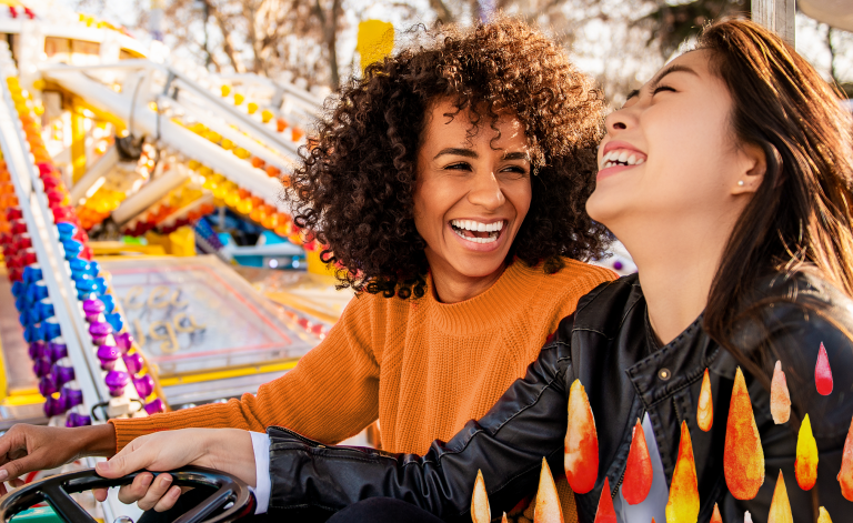 two woman smiling on a ride