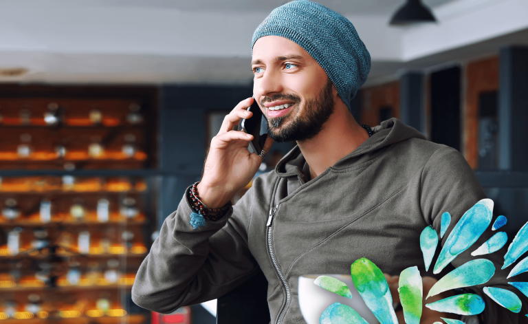 man smiling and talking on the phone