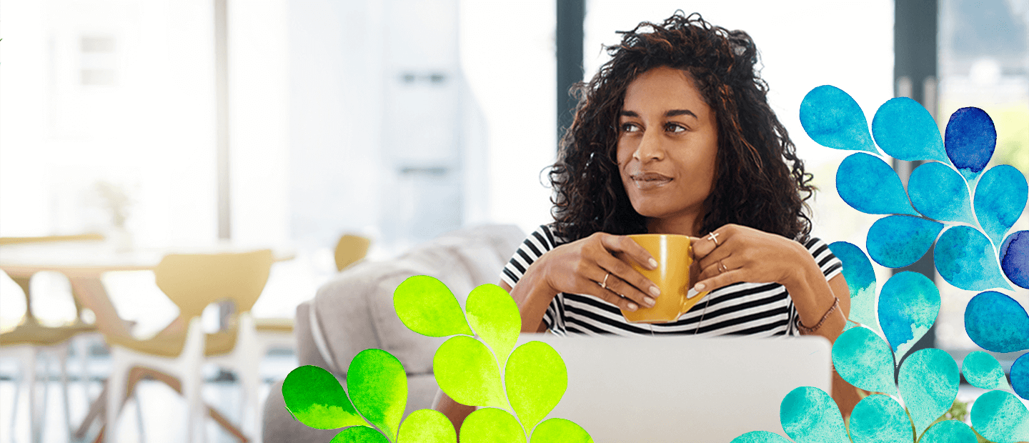 woman smiling and holding a mug in a cafe